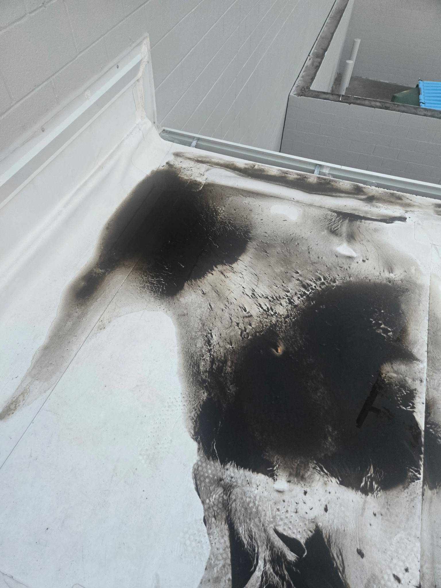 Rooftop showing HVAC coil-cleaning runoff after service
